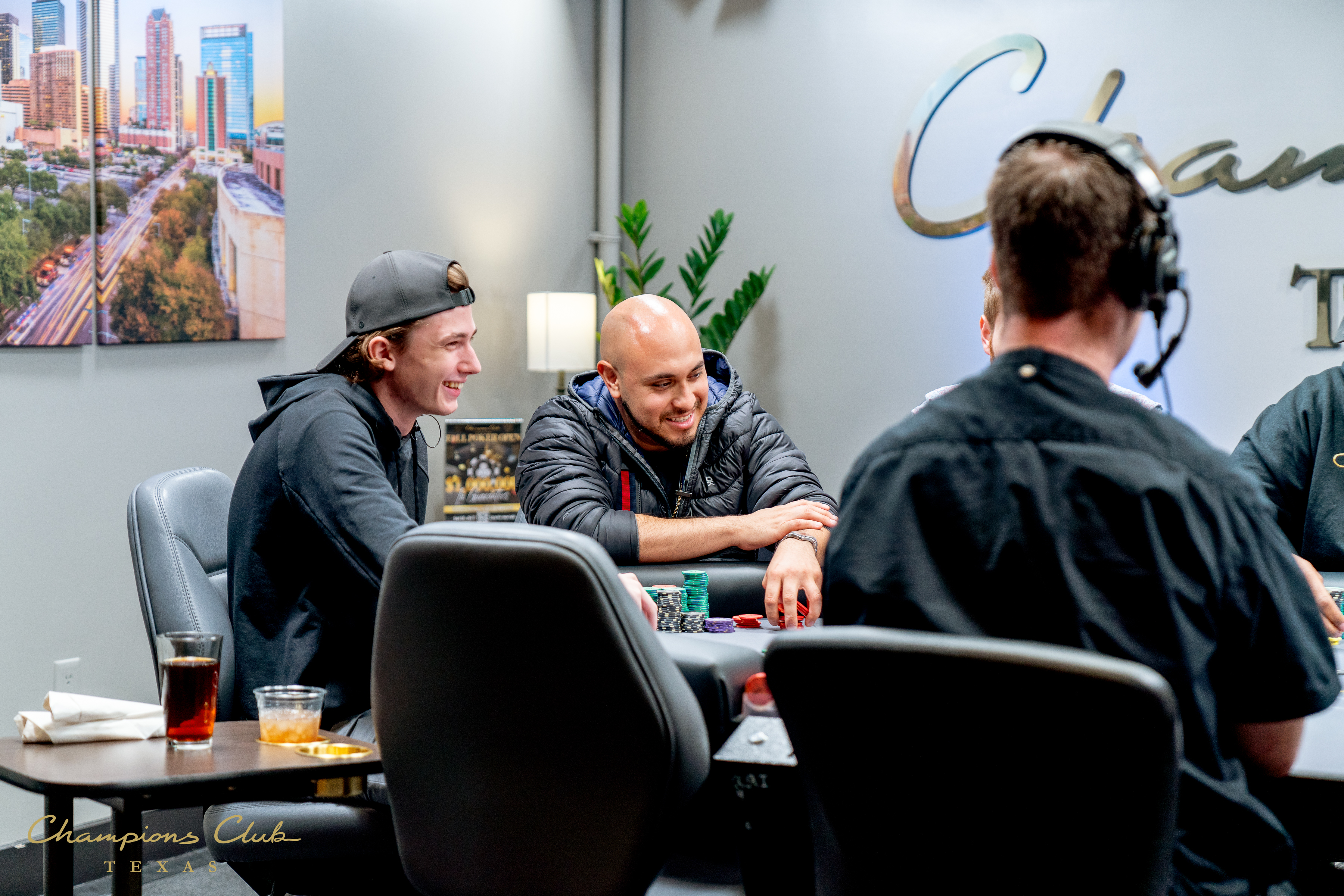 A group of men playing poker at a table in a lounge.